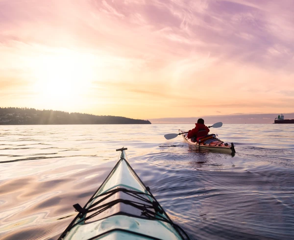 2 people kayaking on a lake 2 people kayaking on a lake